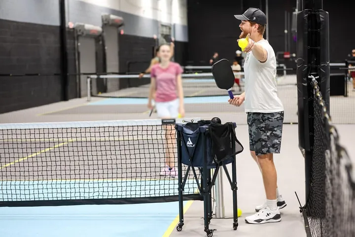 Tanner Rice giving feedback with a ball in hand during a lesson