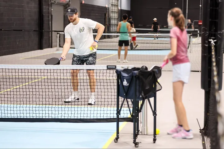 Tanner Rice demonstrating a shot at the net during a lesson at DFW Indoor Pickleball